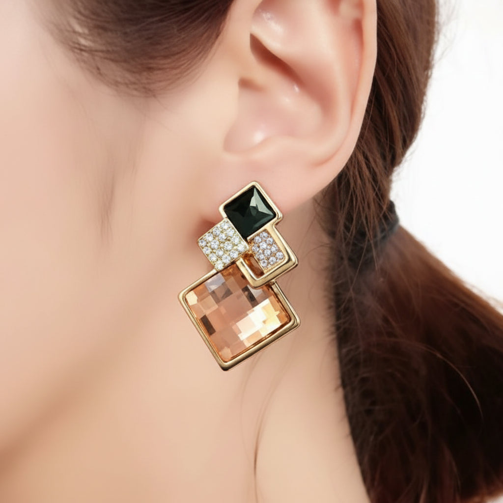 Gold earring with green gemstone worn by a person