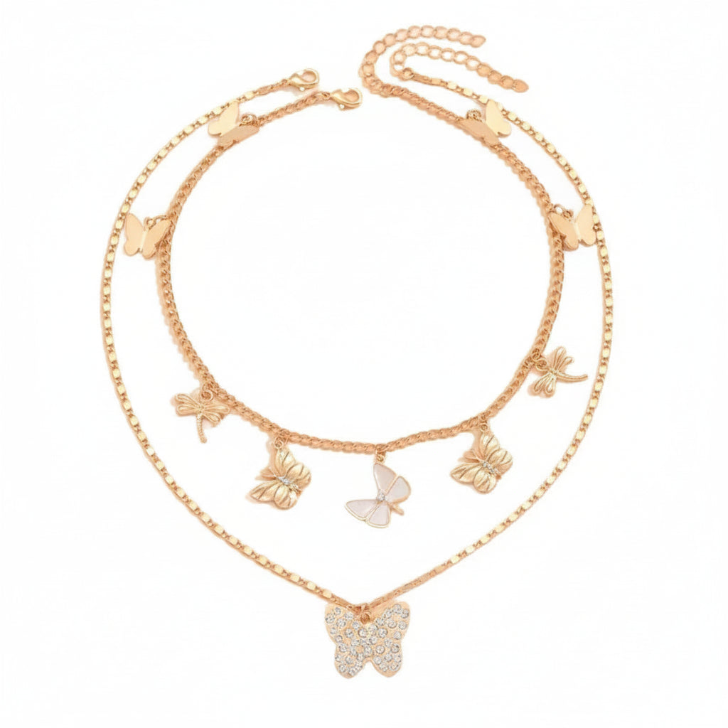 Gold butterfly necklace on a white background