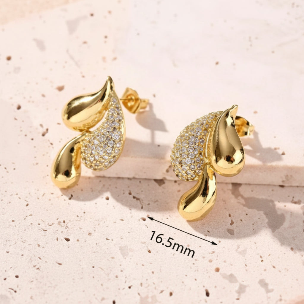 Gold earrings with leaves on a white background