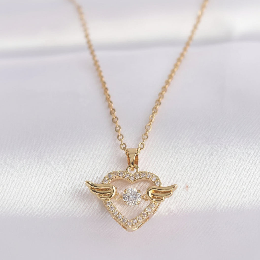 Gold heart-shaped necklace with wings on a white background