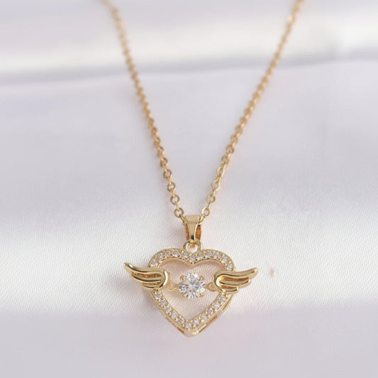 Gold heart-shaped necklace with wings on a white background