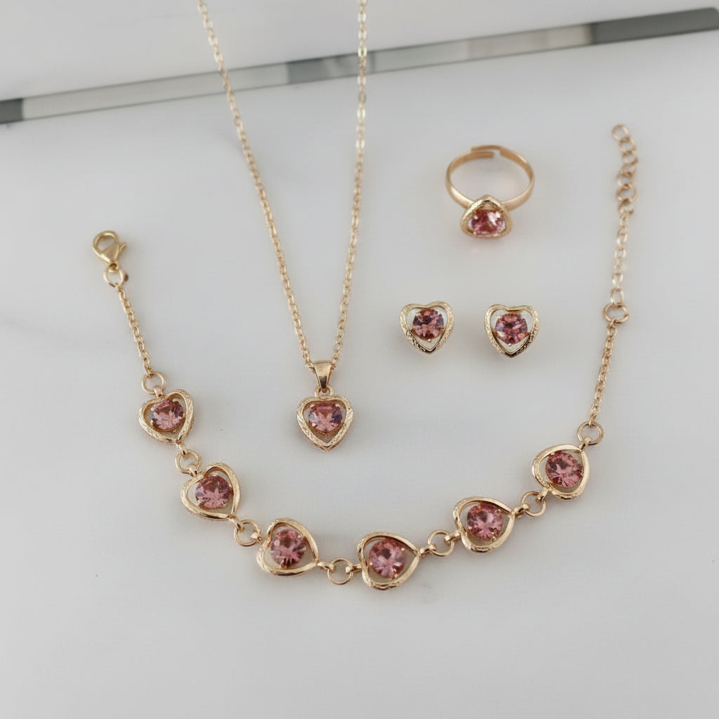 Gold necklace with red gemstones, ring, and earrings on a white background